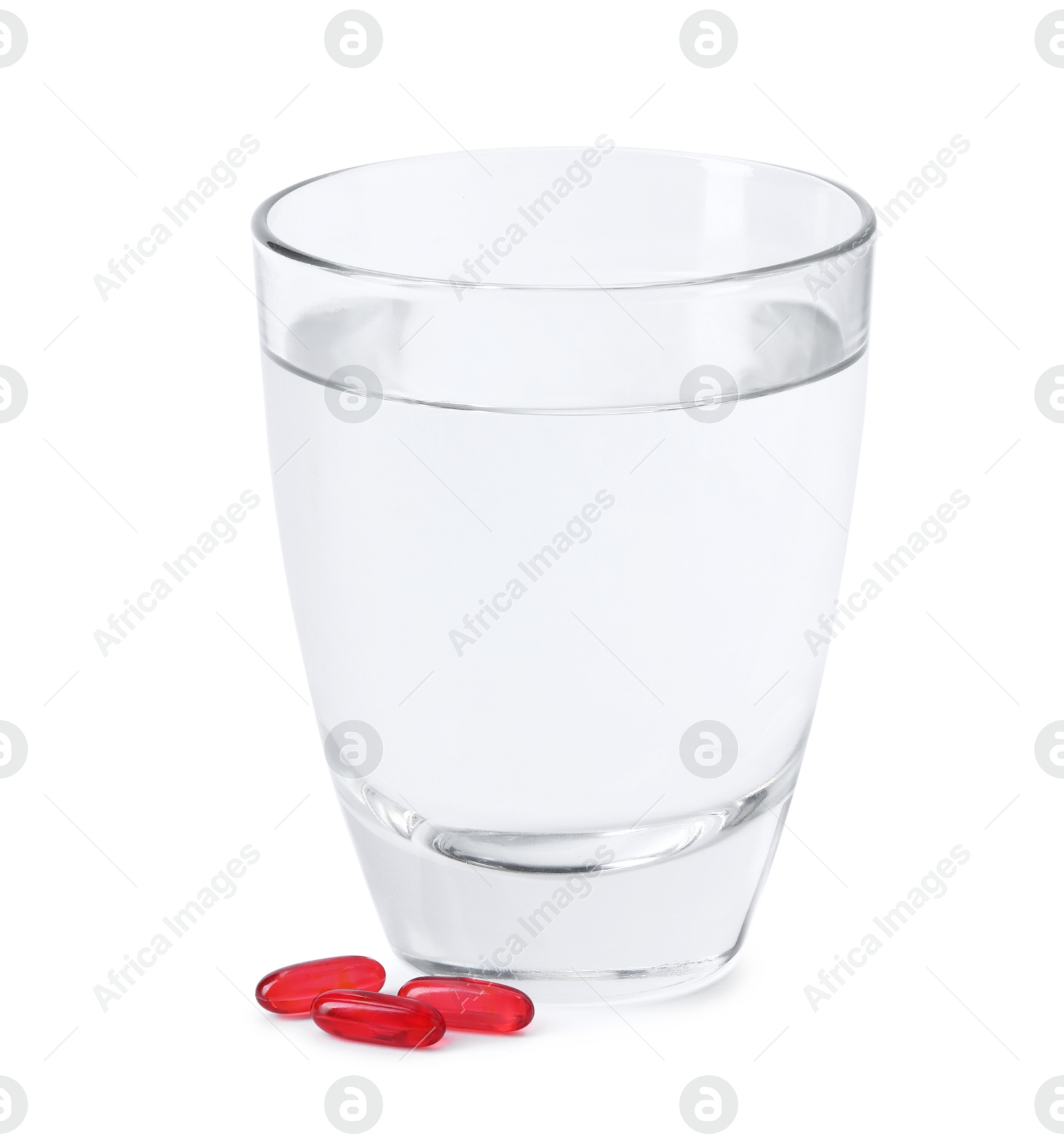 Collagen capsules and glass of water isolated on white Photo of Collagen capsules and glass of water isolated on white