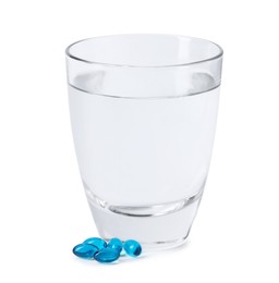 Photo of Collagen capsules and glass of water isolated on white
