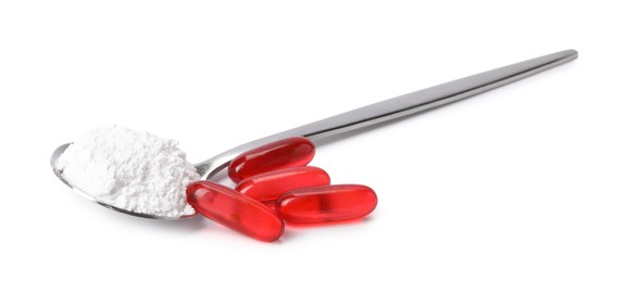 Photo of Collagen powder in spoon and pills isolated on white