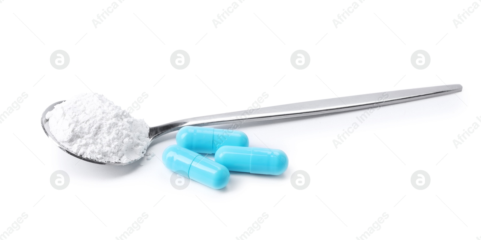 Collagen powder in spoon and pills isolated on white Photo of Collagen powder in spoon and pills isolated on white