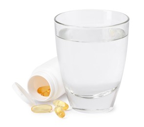 Photo of Collagen capsules in bottle and glass of water isolated on white