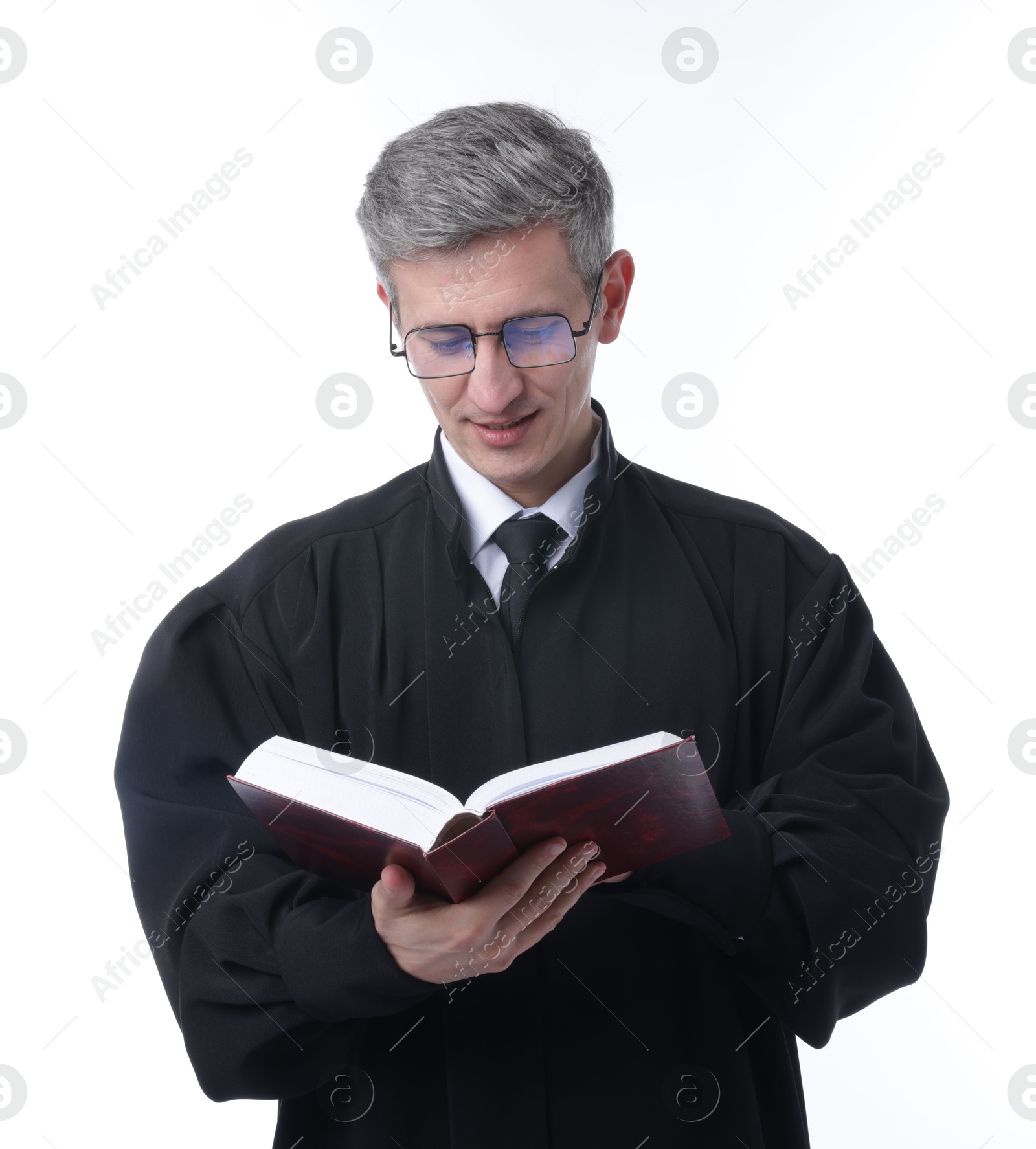 Judge in court dress with book on white background Photo of Judge in court dress with book on white background