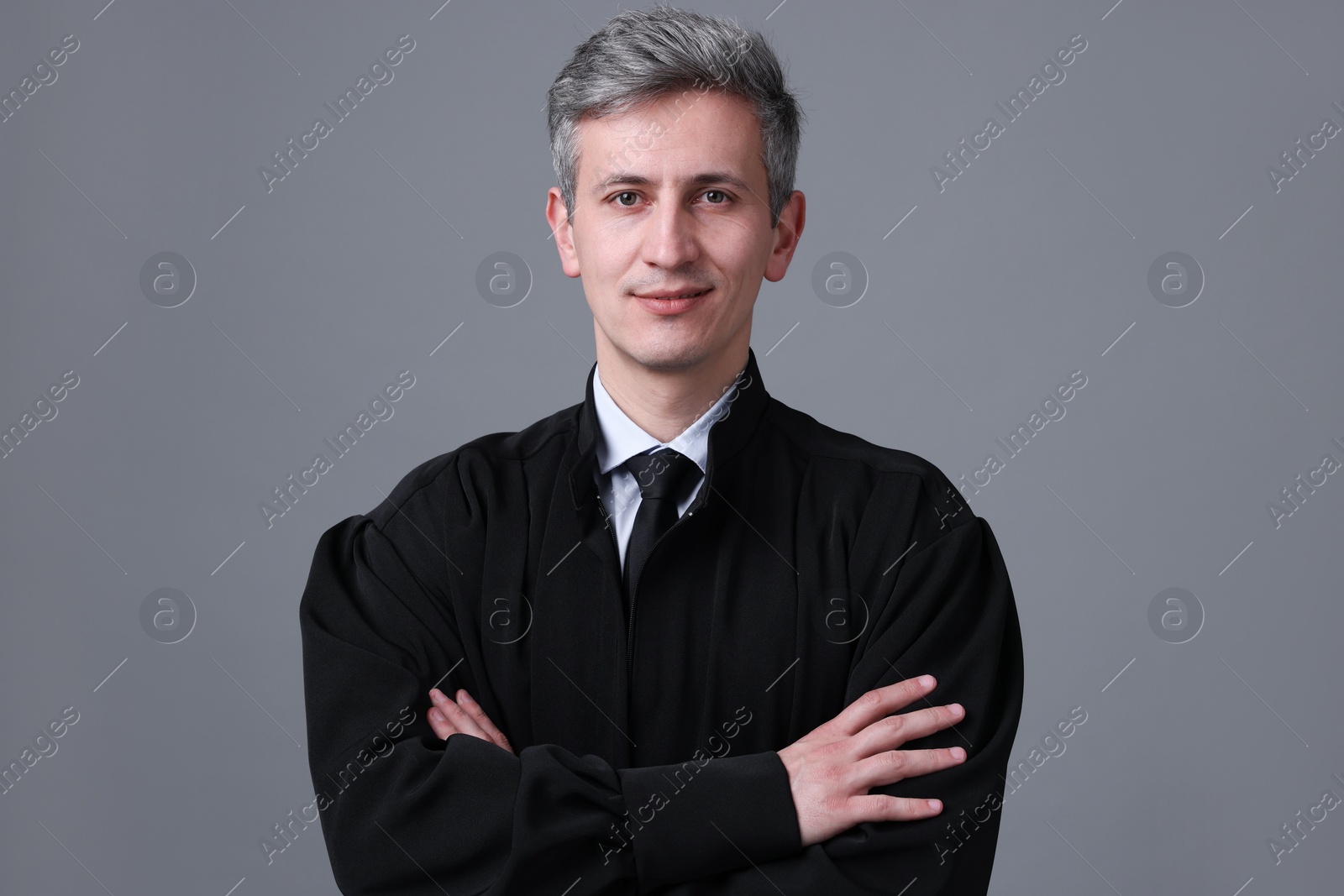 Portrait of judge in court dress on grey background Photo of Portrait of judge in court dress on grey background
