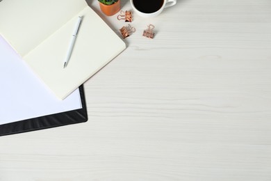 Photo of Flat lay composition with office supplies and cup of coffee on light wooden table. Space for text