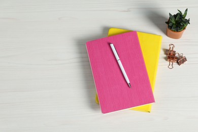 Photo of Flat lay composition with office supplies and houseplant on light wooden table. Space for text