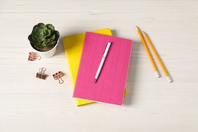 Photo of Flat lay composition with office supplies and houseplant on light wooden table