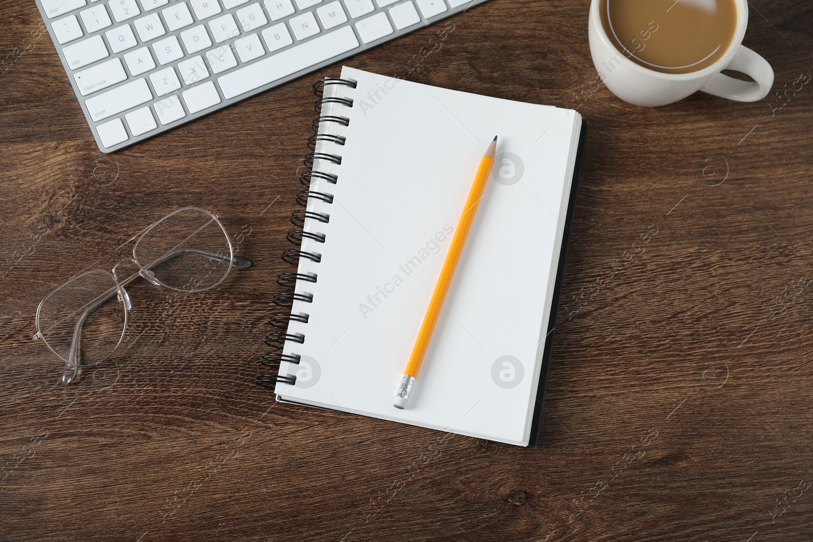 Flat lay composition with office supplies and cup of coffee on wooden table Photo of Flat lay composition with office supplies and cup of coffee on wooden table