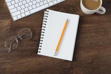Photo of Flat lay composition with office supplies and cup of coffee on wooden table