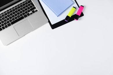 Photo of Office supplies and laptop on white table, flat lay. Space for text