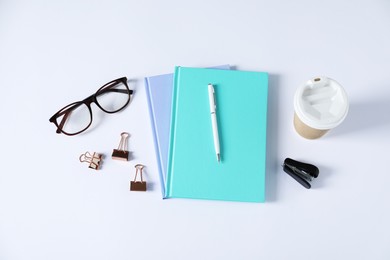 Photo of Flat lay composition with office supplies and takeaway paper cup on white table