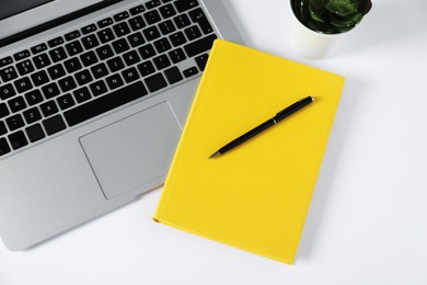 Photo of Office supplies, laptop and houseplant on white table, flat lay