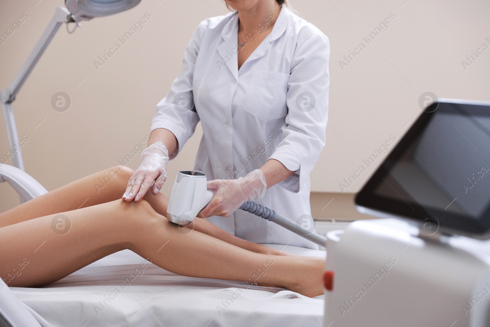 Woman during laser depilation procedure in beauty salon, closeup Photo of Woman during laser depilation procedure in beauty salon, closeup