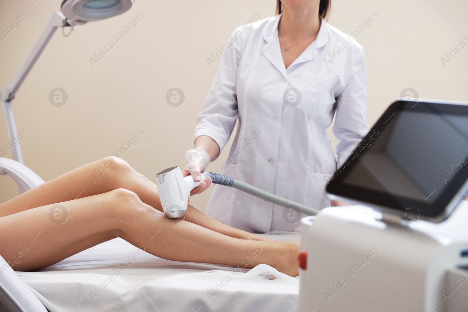 Woman during laser depilation procedure in beauty salon, closeup Photo of Woman during laser depilation procedure in beauty salon, closeup