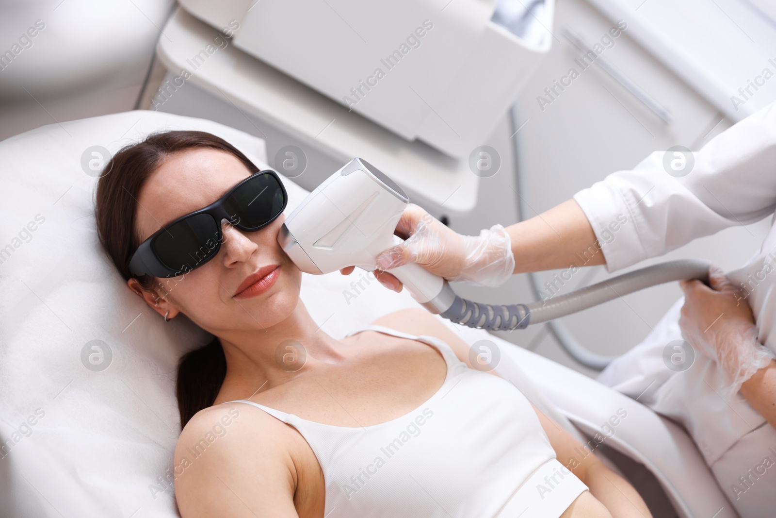 Woman during laser depilation procedure in beauty salon Photo of Woman during laser depilation procedure in beauty salon