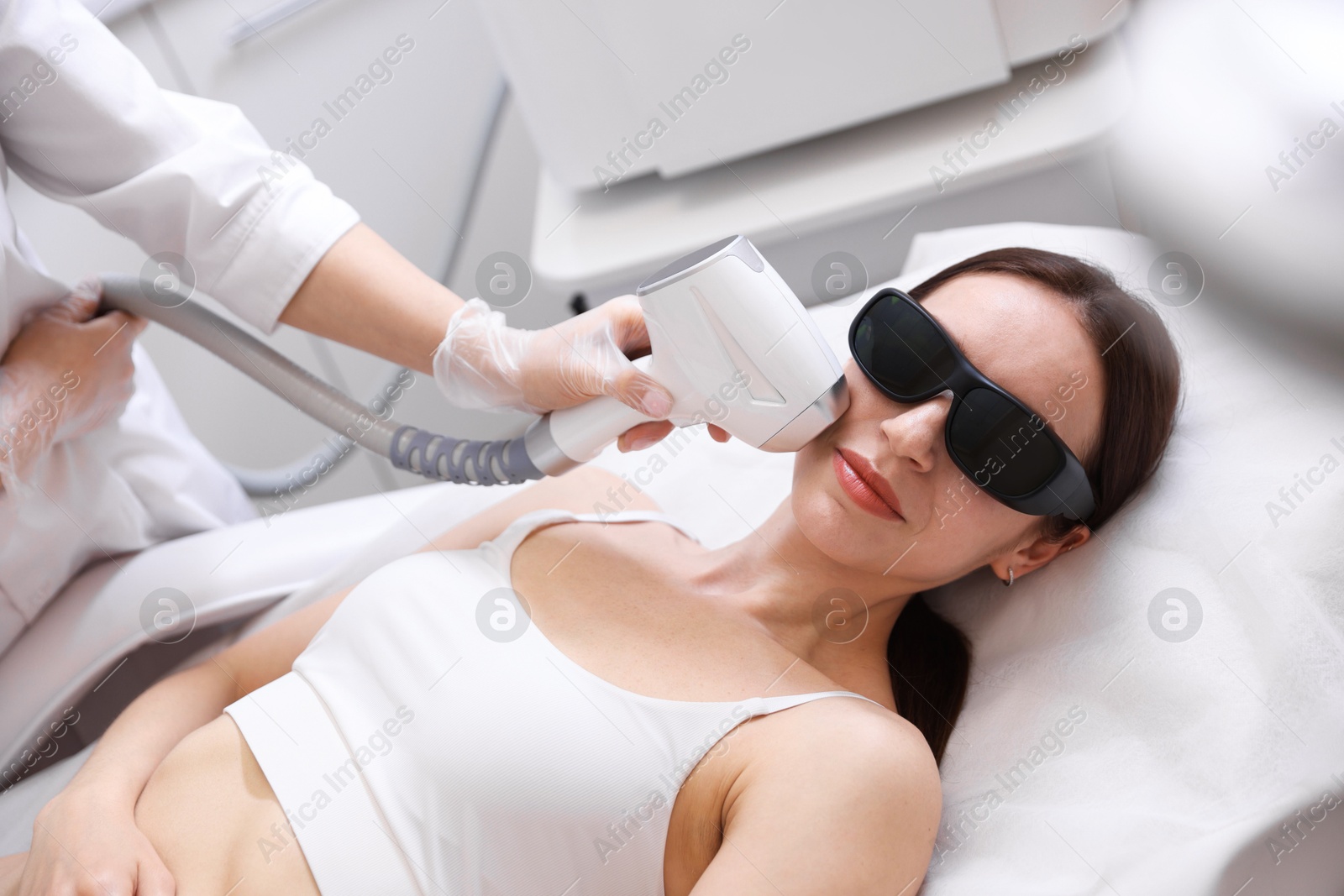 Woman during laser depilation procedure in beauty salon Photo of Woman during laser depilation procedure in beauty salon