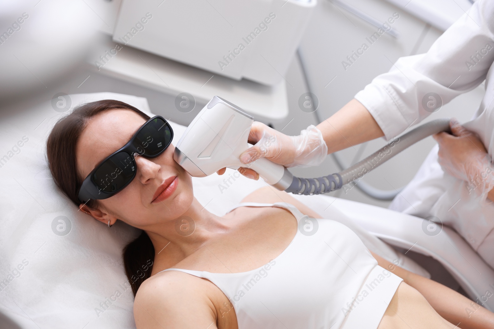 Woman during laser depilation procedure in beauty salon Photo of Woman during laser depilation procedure in beauty salon