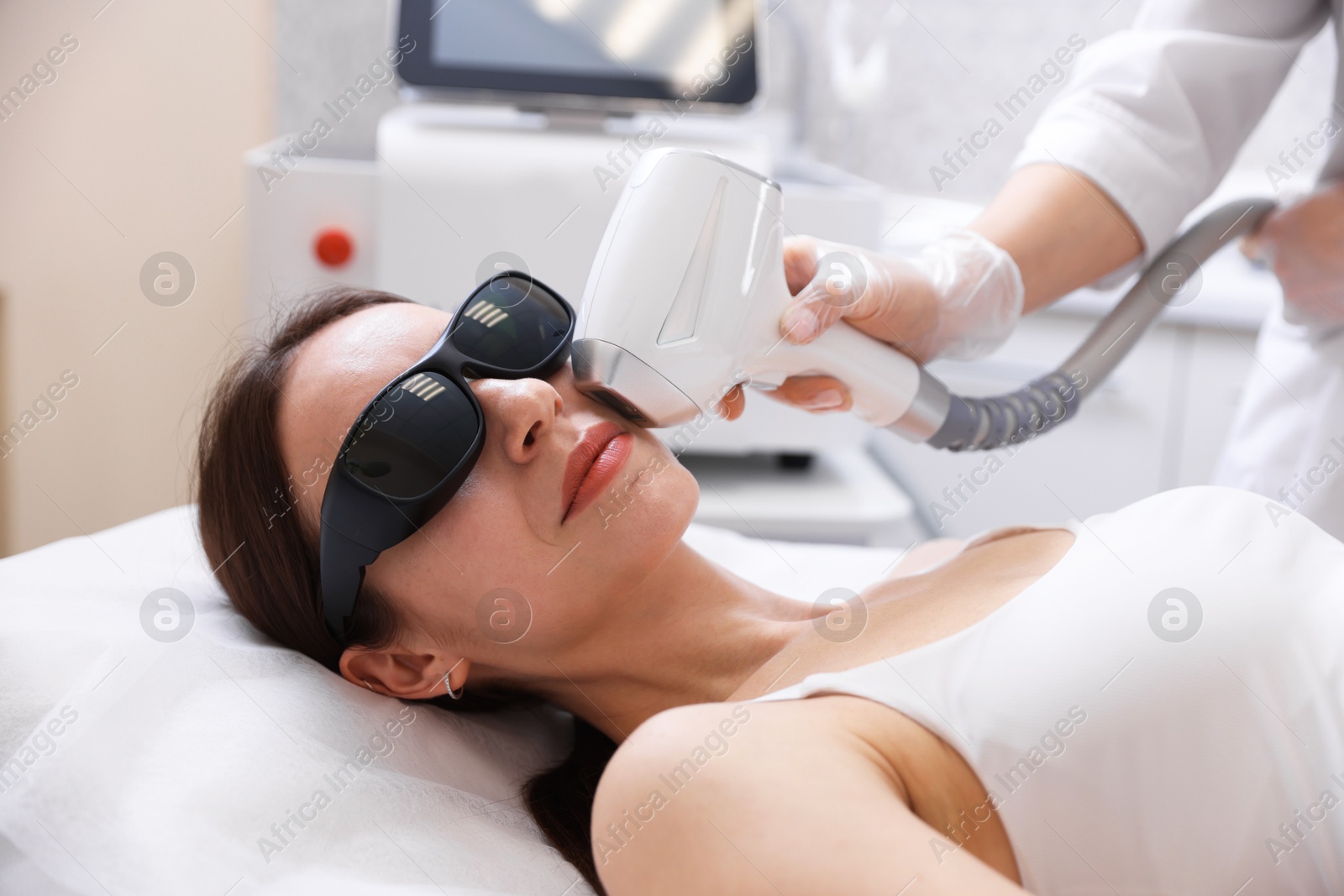 Woman during laser depilation procedure in beauty salon Photo of Woman during laser depilation procedure in beauty salon