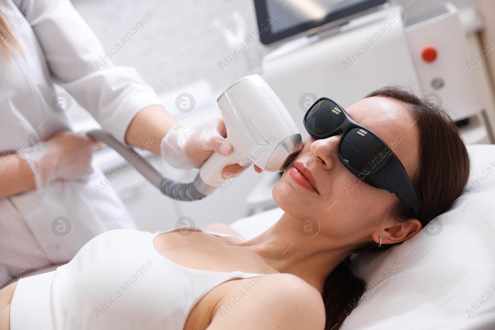 Woman during laser depilation procedure in beauty salon Photo of Woman during laser depilation procedure in beauty salon