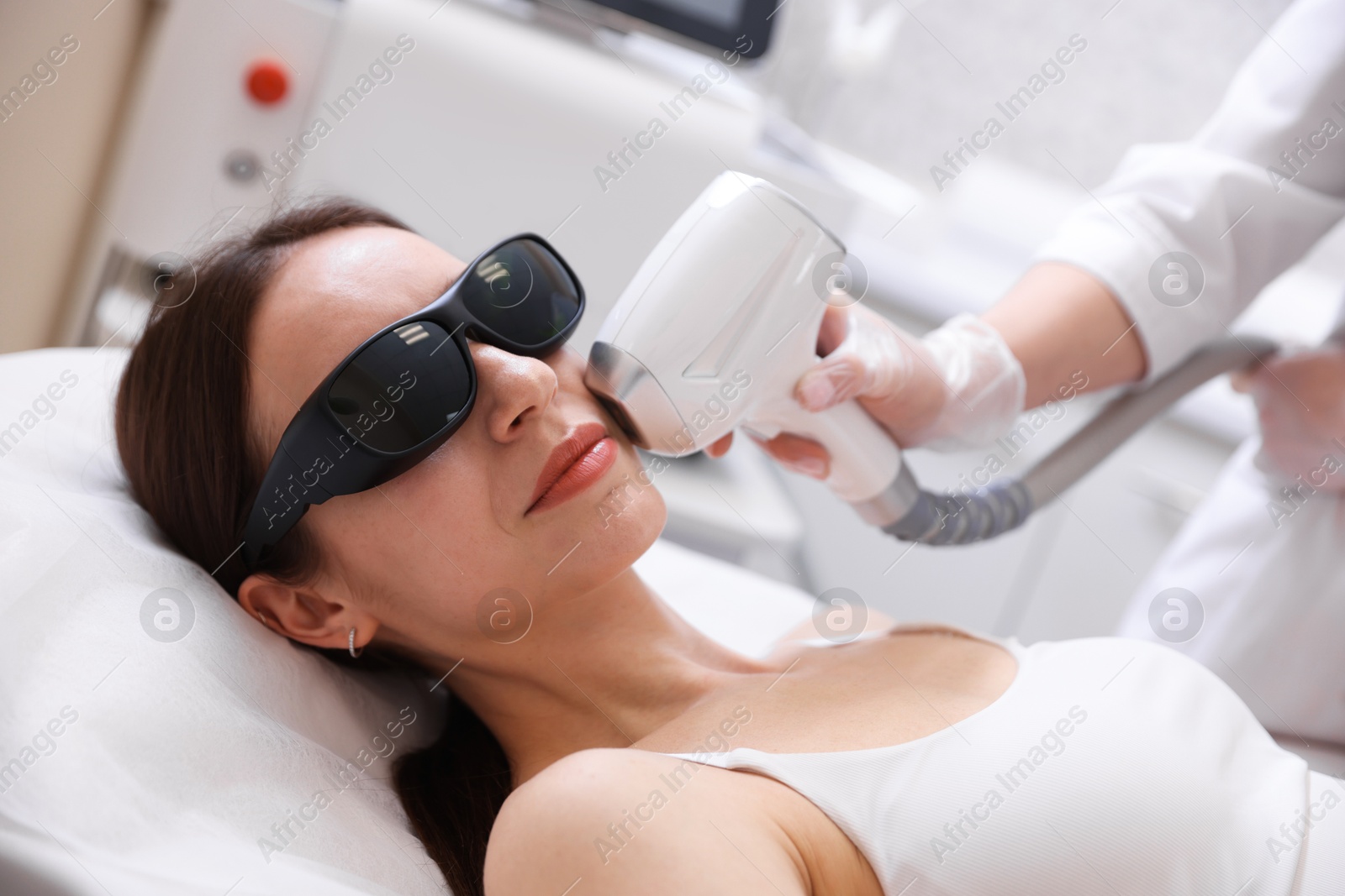 Woman during laser depilation procedure in beauty salon Photo of Woman during laser depilation procedure in beauty salon