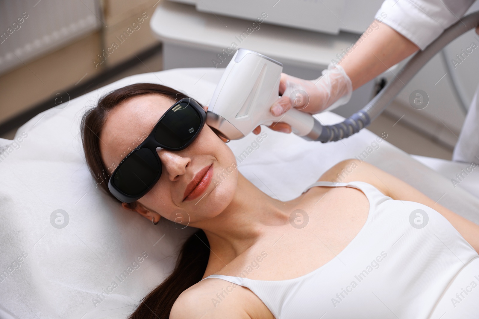 Woman during laser depilation procedure in beauty salon Photo of Woman during laser depilation procedure in beauty salon
