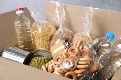 Photo of Different food products in box on gray background, closeup