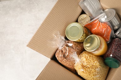Photo of Different food products in box on gray table, top view