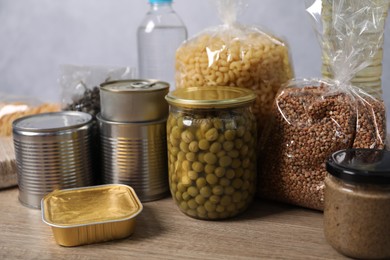 Photo of Different food products on wooden table, closeup