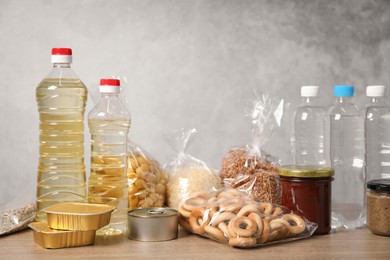 Photo of Many different food products on wooden table