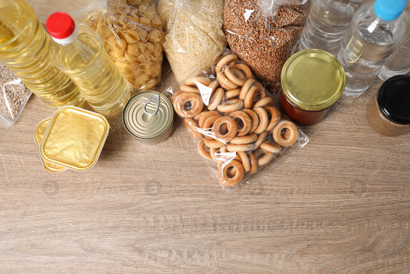 Different food products on wooden table, flat lay. Space for text Photo of Different food products on wooden table, flat lay. Space for text