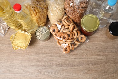 Photo of Different food products on wooden table, flat lay. Space for text