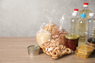 Photo of Different food products on wooden table, space for text