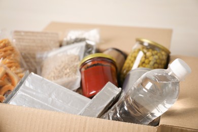 Photo of Different food products in box on gray background, closeup