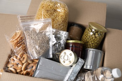 Photo of Different food products in box on table, above view