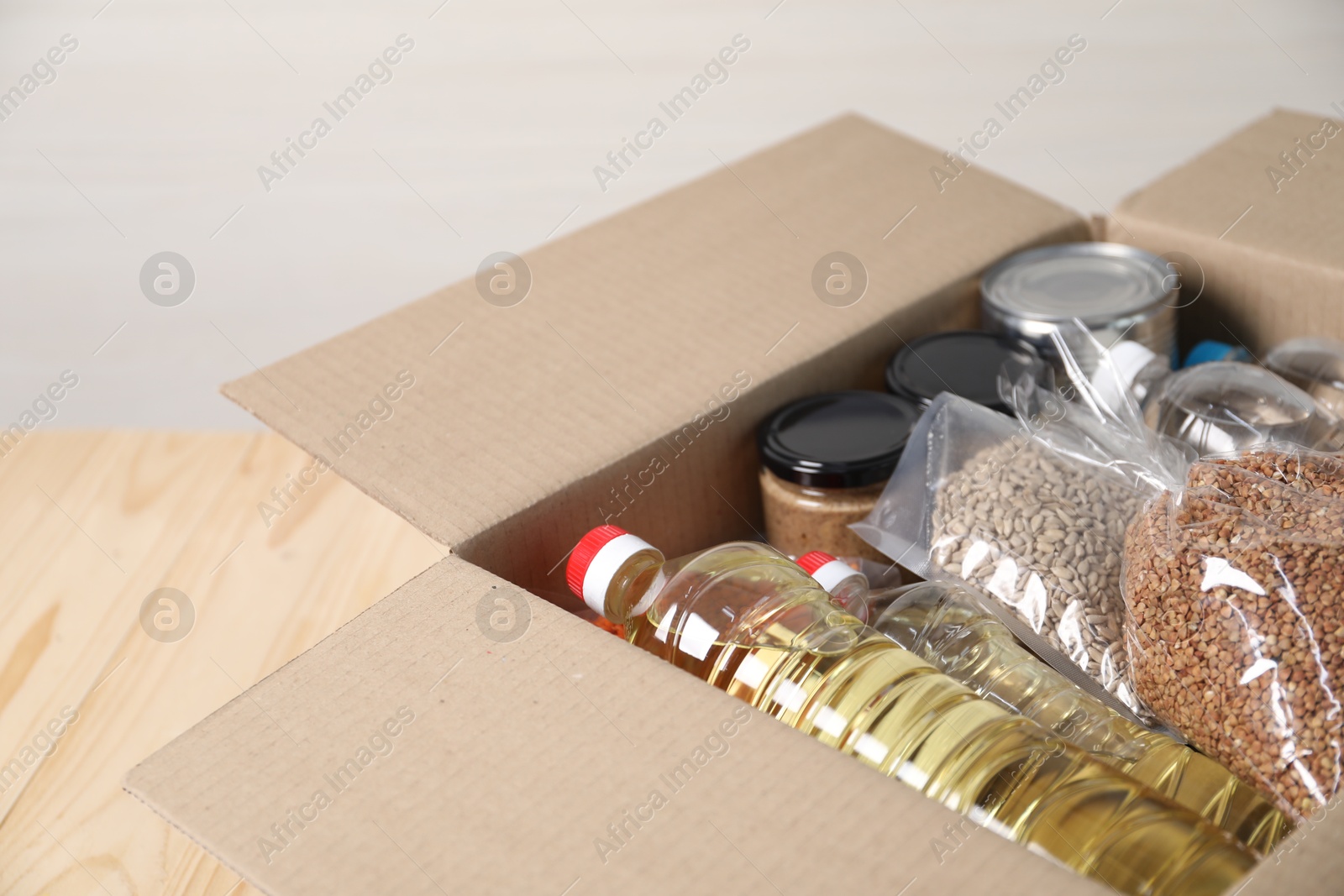 Different food products in box on table, closeup Photo of Different food products in box on table, closeup