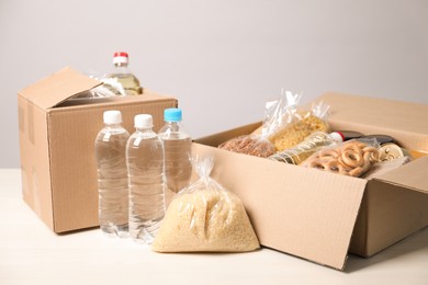 Photo of Different food products in boxes on light table