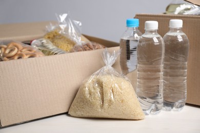 Photo of Different food products in boxes on light table, closeup