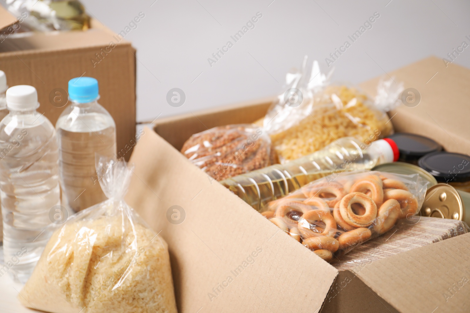 Different food products in boxes on light table, closeup Photo of Different food products in boxes on light table, closeup