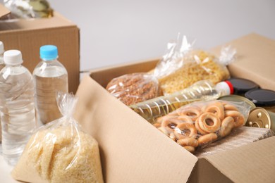 Photo of Different food products in boxes on light table, closeup