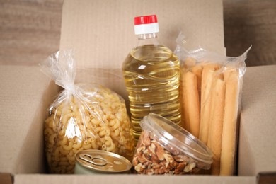 Photo of Different food products in box on table, closeup