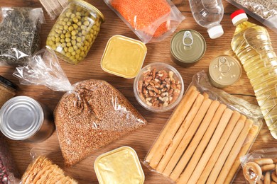 Photo of Different food products on wooden table, flat lay
