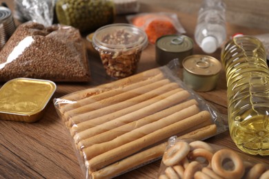 Photo of Different food products on wooden table, closeup