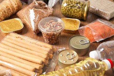 Photo of Different food products on wooden table, closeup