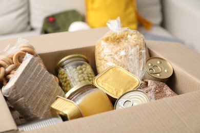 Photo of Survival kit. Different food products in box indoors, closeup