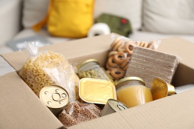 Photo of Survival kit. Different food products in box indoors, closeup