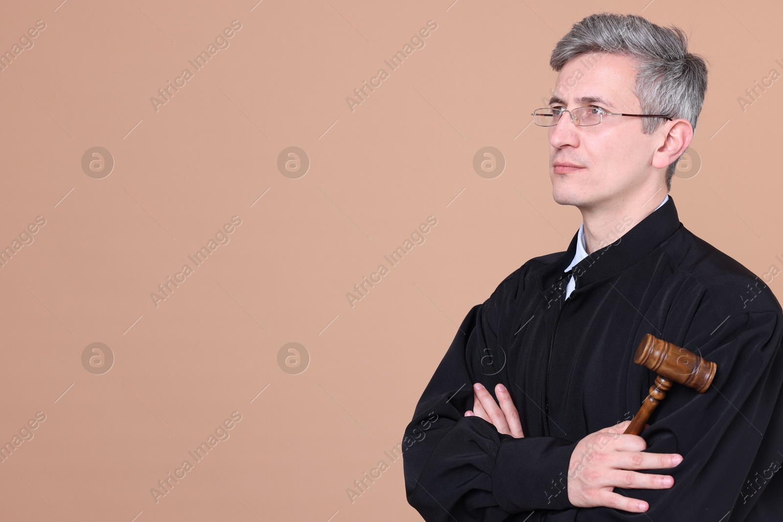 Judge with mallet on beige background. Space for text Photo of Judge with mallet on beige background. Space for text