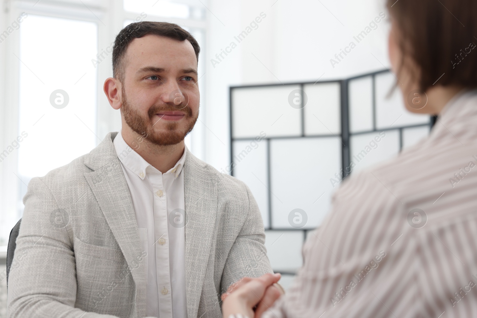 Recruiter and candidate shaking hands in office Photo of Recruiter and candidate shaking hands in office