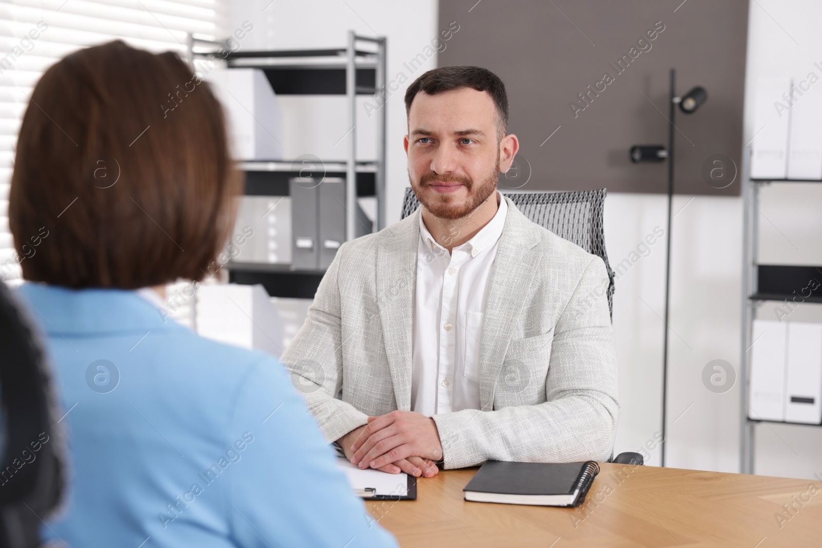 Recruiter and candidate having job interview at desk in office Photo of Recruiter and candidate having job interview at desk in office