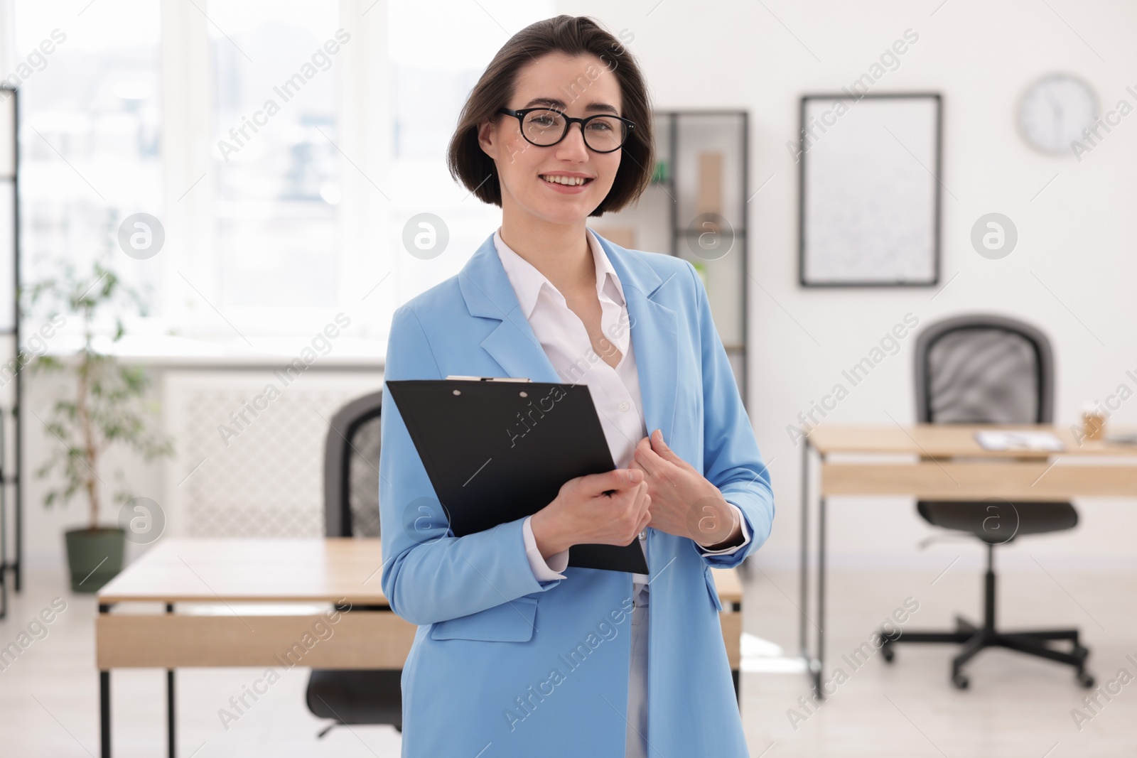 Happy recruiter with clipboard in office. Job interview Photo of Happy recruiter with clipboard in office. Job interview