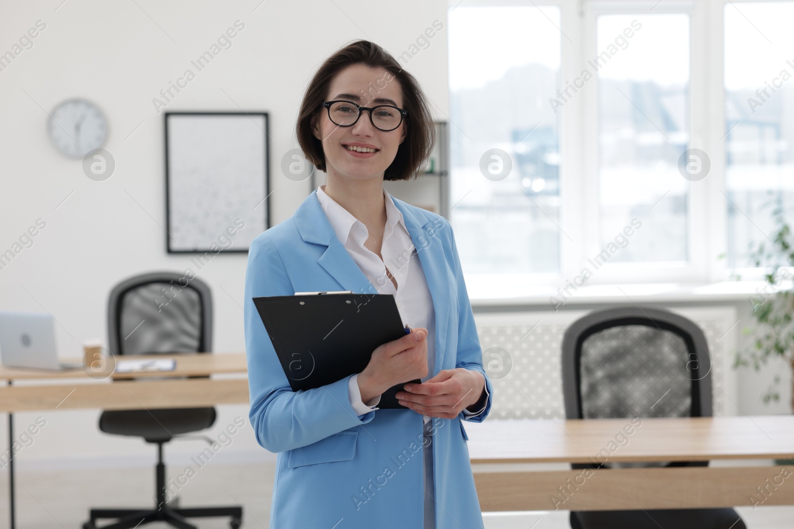 Photo of Happy recruiter with clipboard in office. Job interview