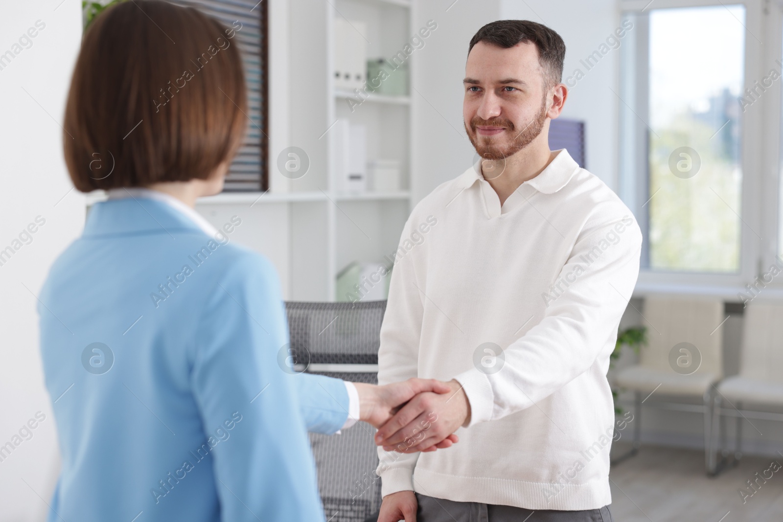 Recruiter and candidate shaking hands in office Photo of Recruiter and candidate shaking hands in office
